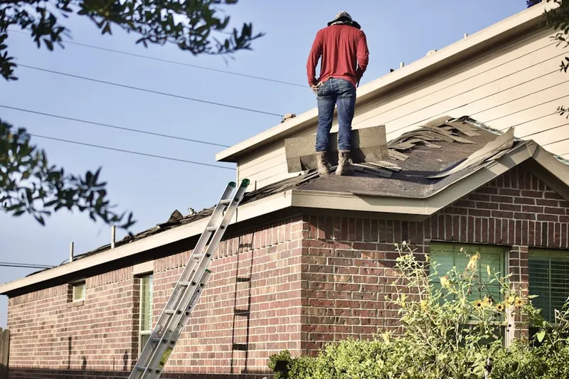 Professional roofer working on a residential roof in Ringoes